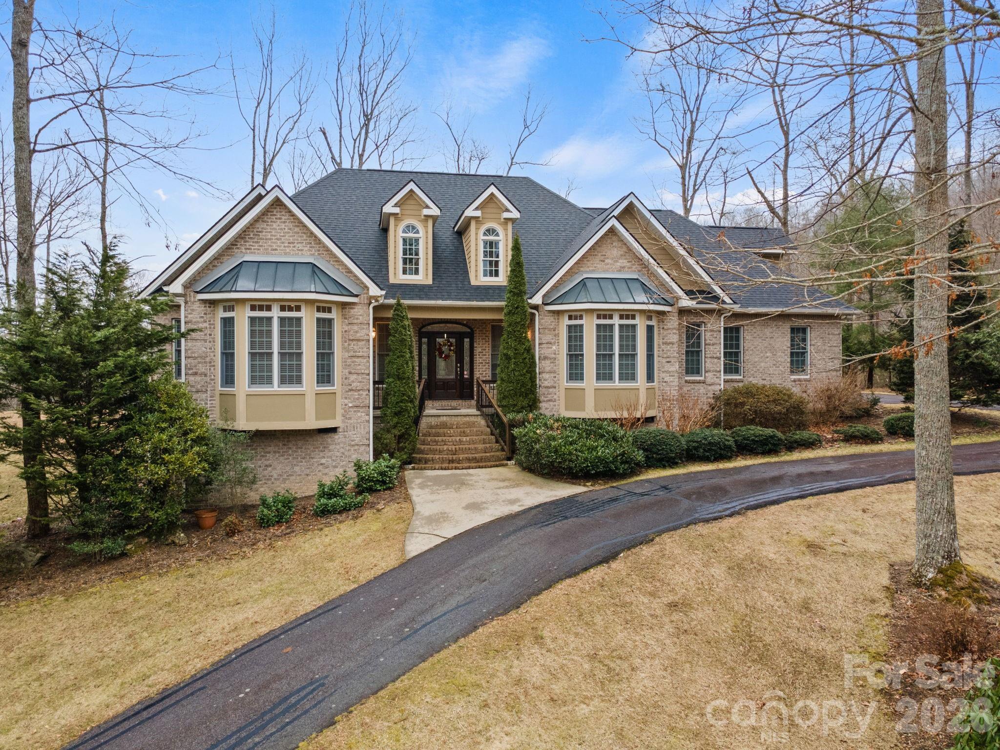 199 Judson Ridge Road Arden, NC 28704 - Photo 2 of 48 a front view of a house with garden