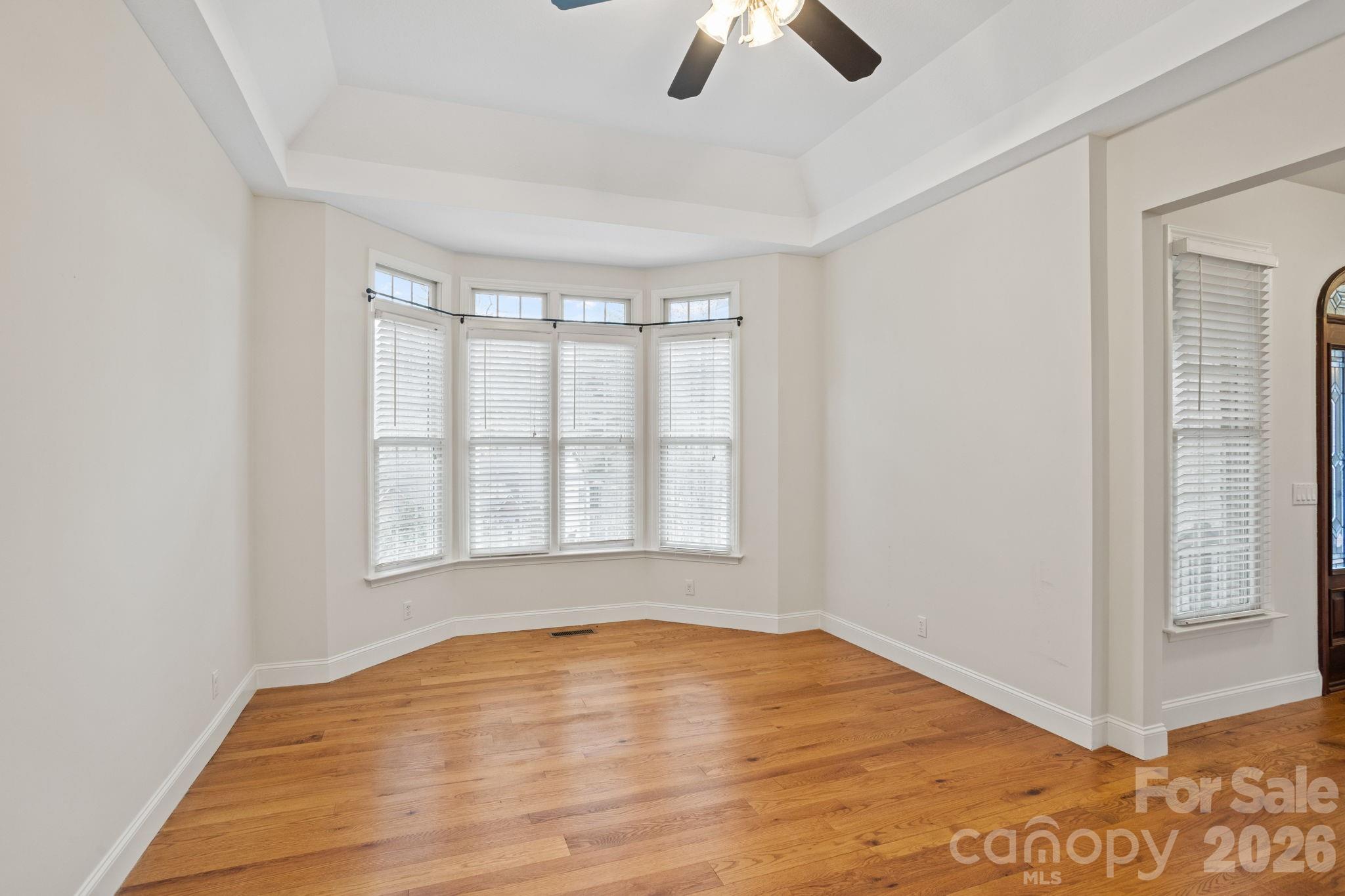 199 Judson Ridge Road Arden, NC 28704 - Photo 22 of 48 an empty room with wooden floor fan and windows
