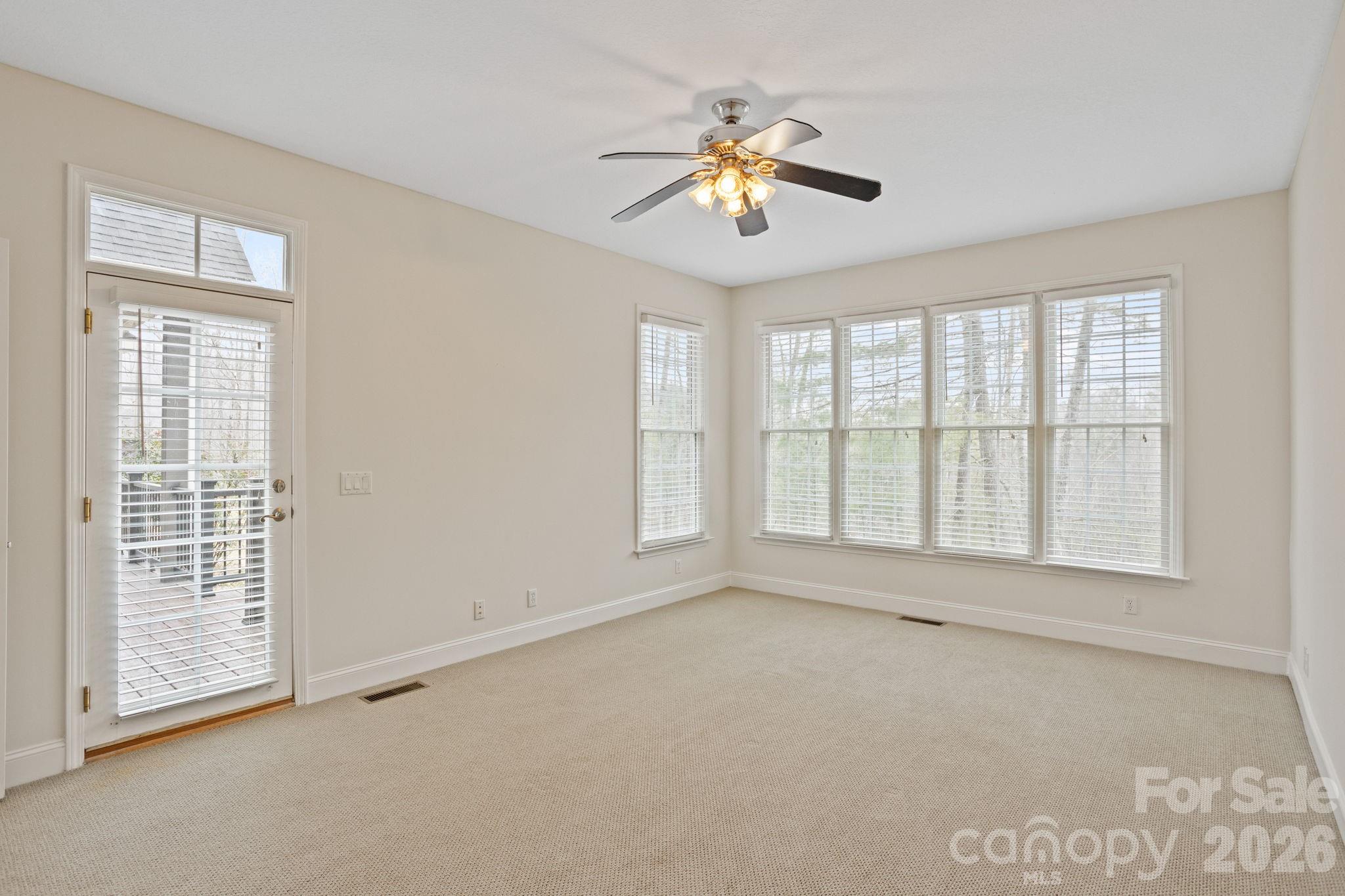 199 Judson Ridge Road Arden, NC 28704 - Photo 26 of 48 an empty room with chandelier fan and windows