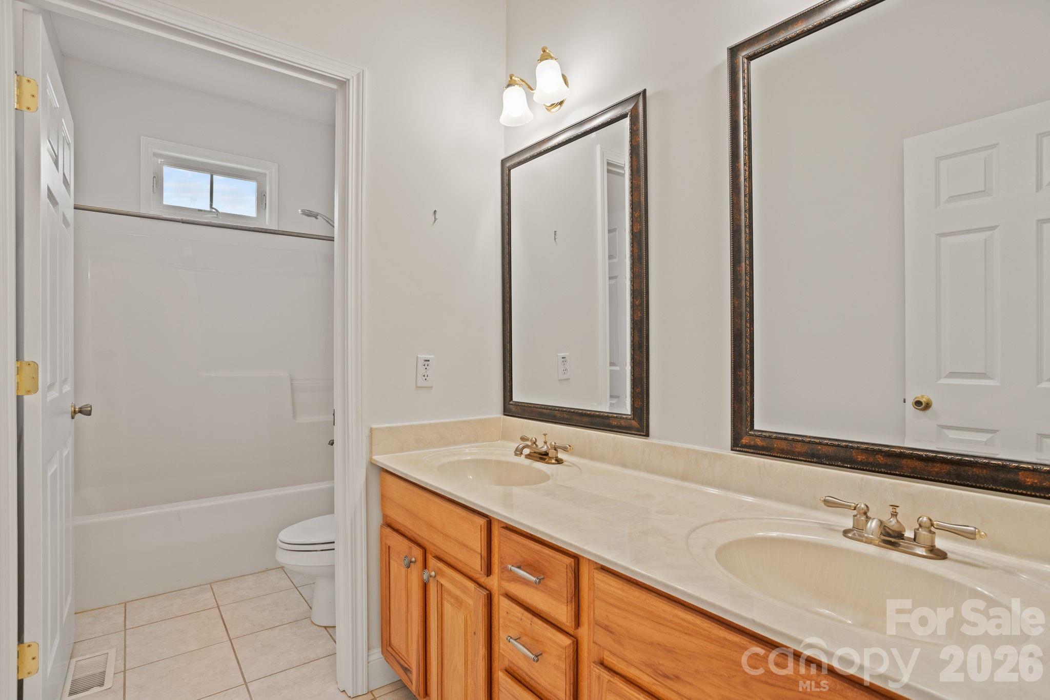 199 Judson Ridge Road Arden, NC 28704 - Photo 37 of 48 a bathroom with a granite countertop sink a toilet and shower