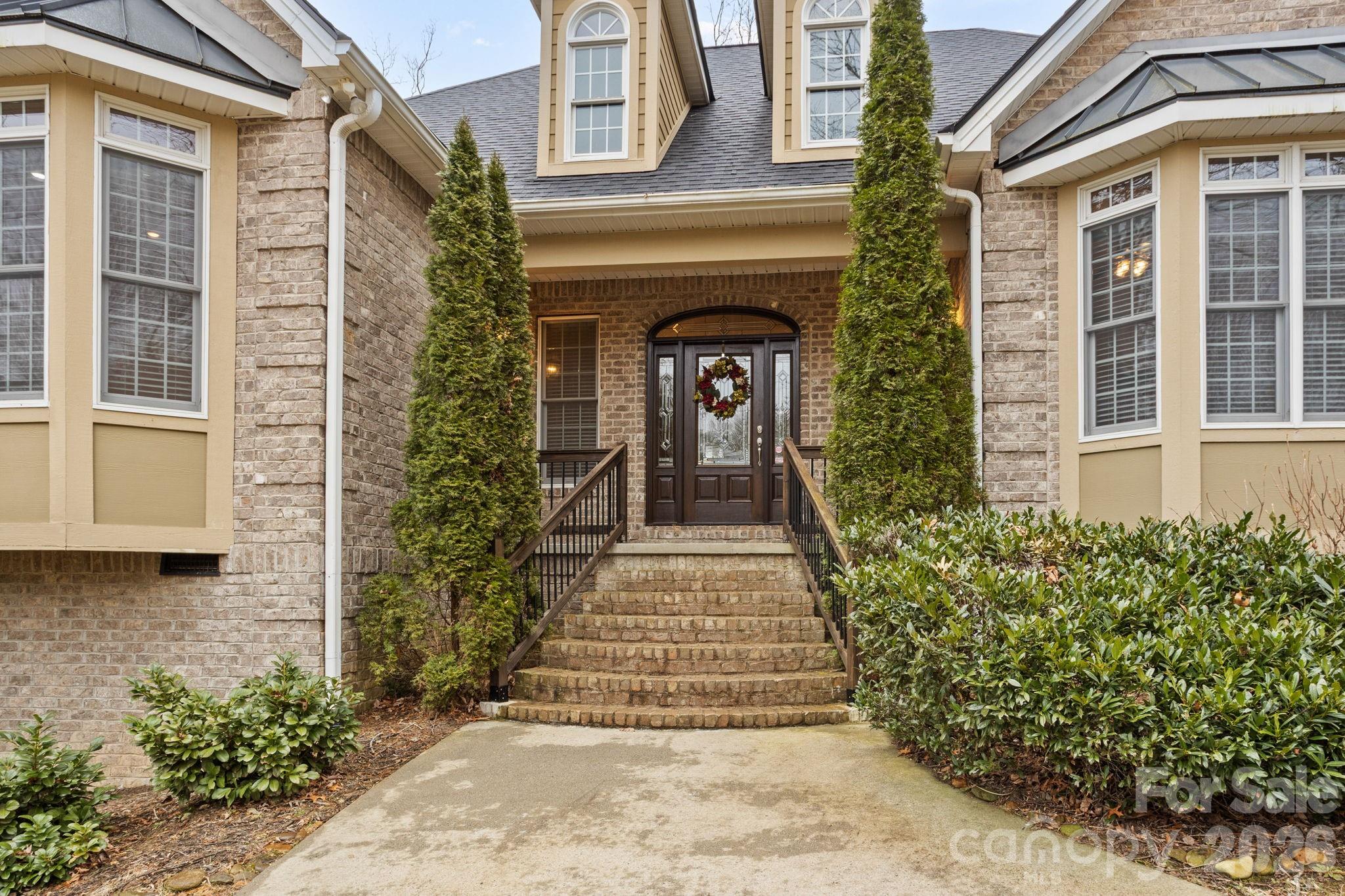 199 Judson Ridge Road Arden, NC 28704 - Photo 6 of 48 a front view of a house with a garden
