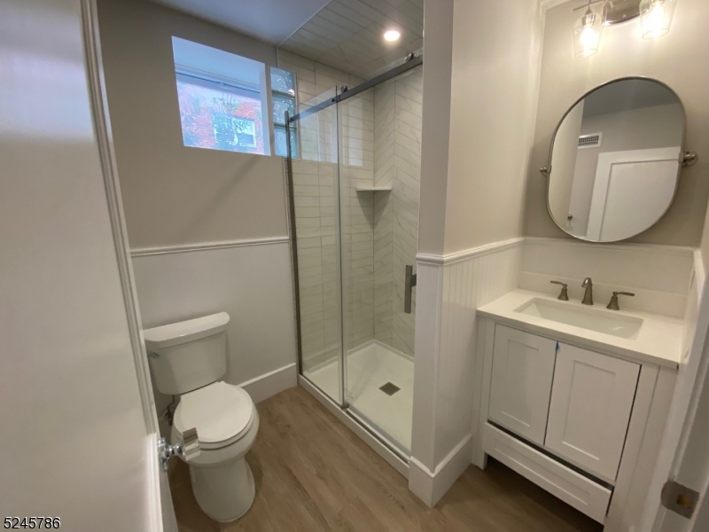 41 Harrison Avenue, Unit 1 Montclair, NJ 07042 - Photo 15 of 16 a bathroom with a toilet sink and shower