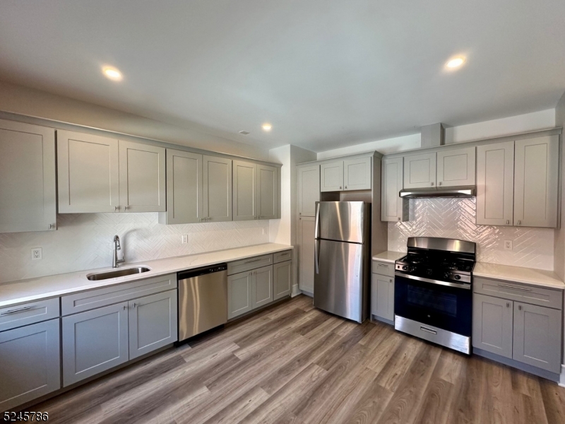 41 Harrison Avenue, Unit 1 Montclair, NJ 07042 - Photo 4 of 16 a kitchen with stainless steel appliances a refrigerator sink and cabinets