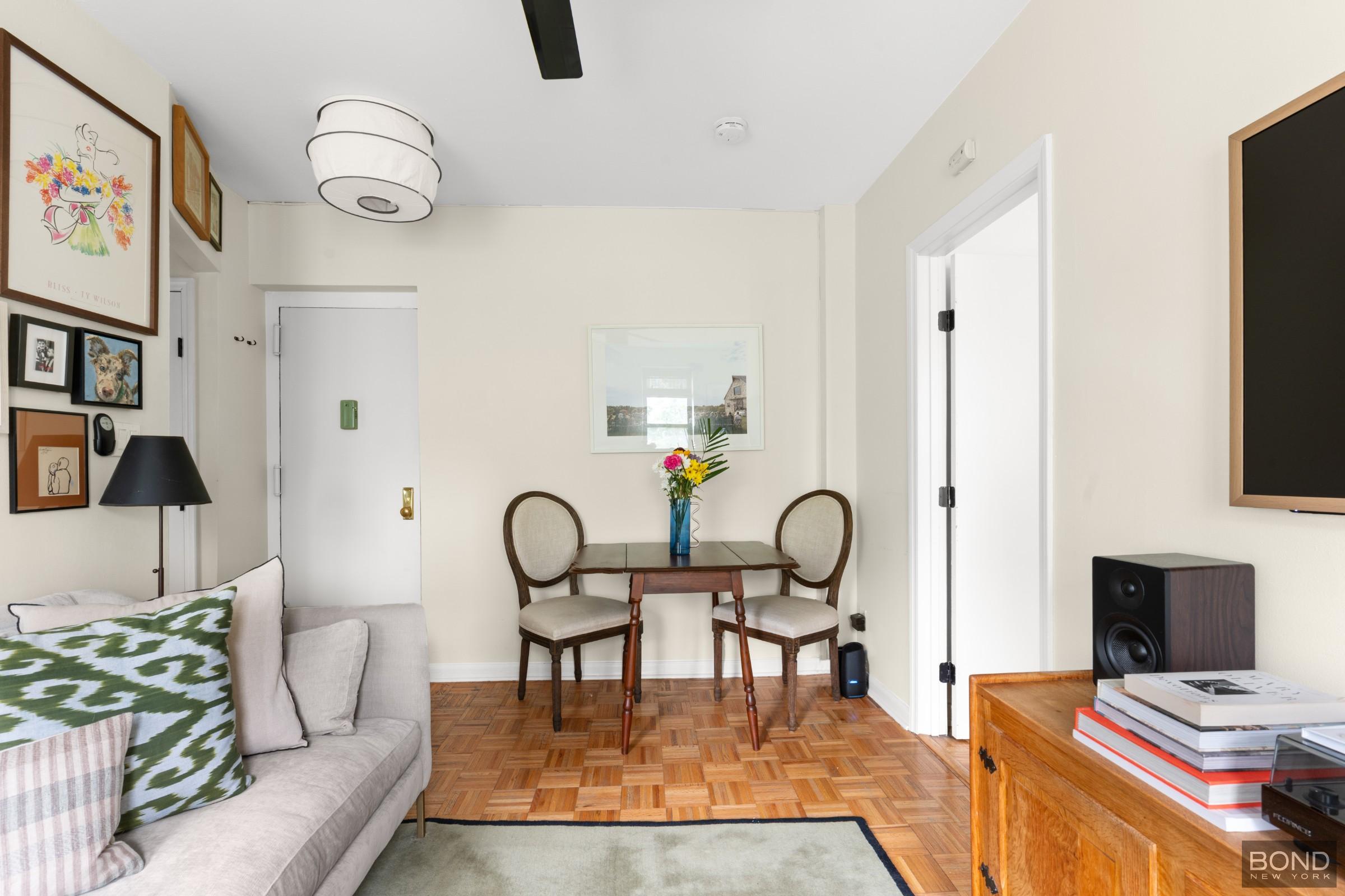 124 South 3rd Street, Unit 8 Brooklyn, NY 11249 - Photo 2 of 6 a living room with furniture and a flat screen tv