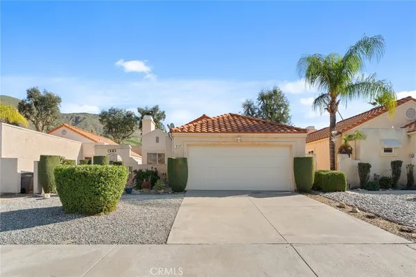 a view of a house with a yard and plants