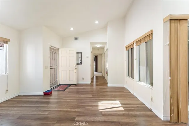 a view of a living room with wooden floor and window