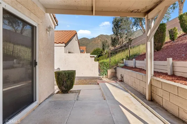 a view of a garden filled with plants and seating area