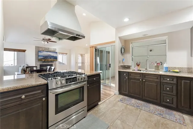 a kitchen with stainless steel appliances granite countertop a stove and a sink
