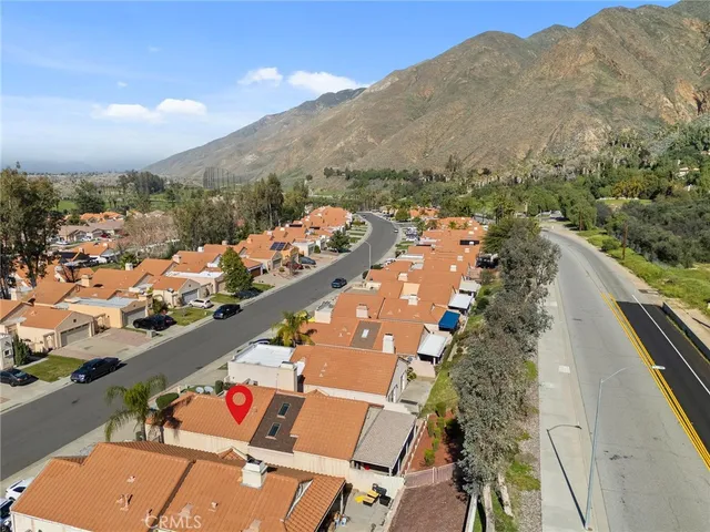 an aerial view of a house with a yard patio and outdoor seating