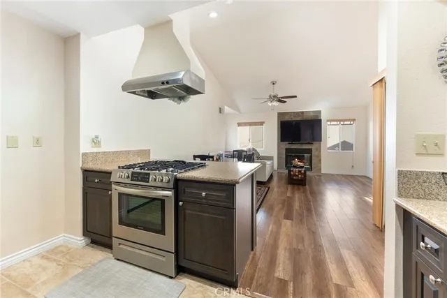 a kitchen with a stove and a wooden floors