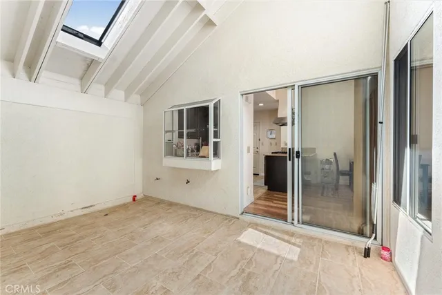 a view of a big room with wooden floor and windows