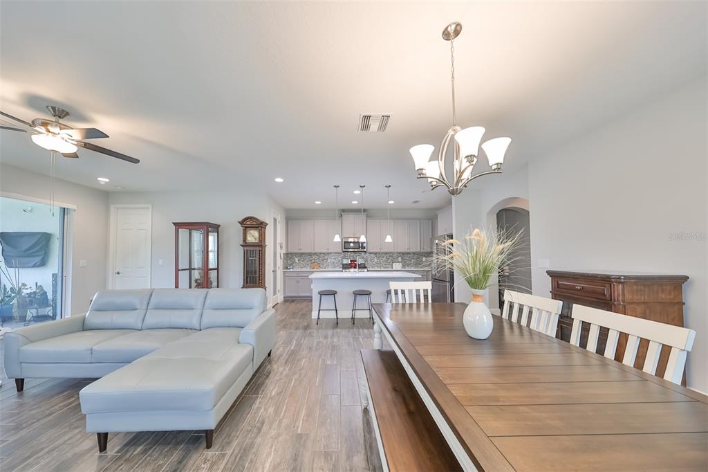 7411 Windport Lane Apollo Beach, FL 33572 - Photo 16 of 71 a living room with dining table and a chandelier