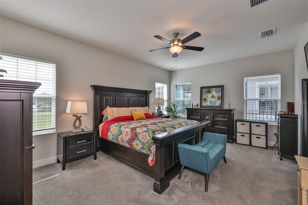 7411 Windport Lane Apollo Beach, FL 33572 - Photo 21 of 71 a bedroom with a bed and a chandelier
