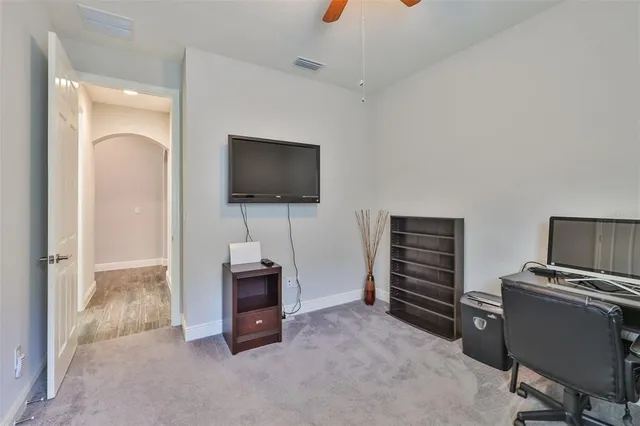 a bedroom with a bed table and a potted plant