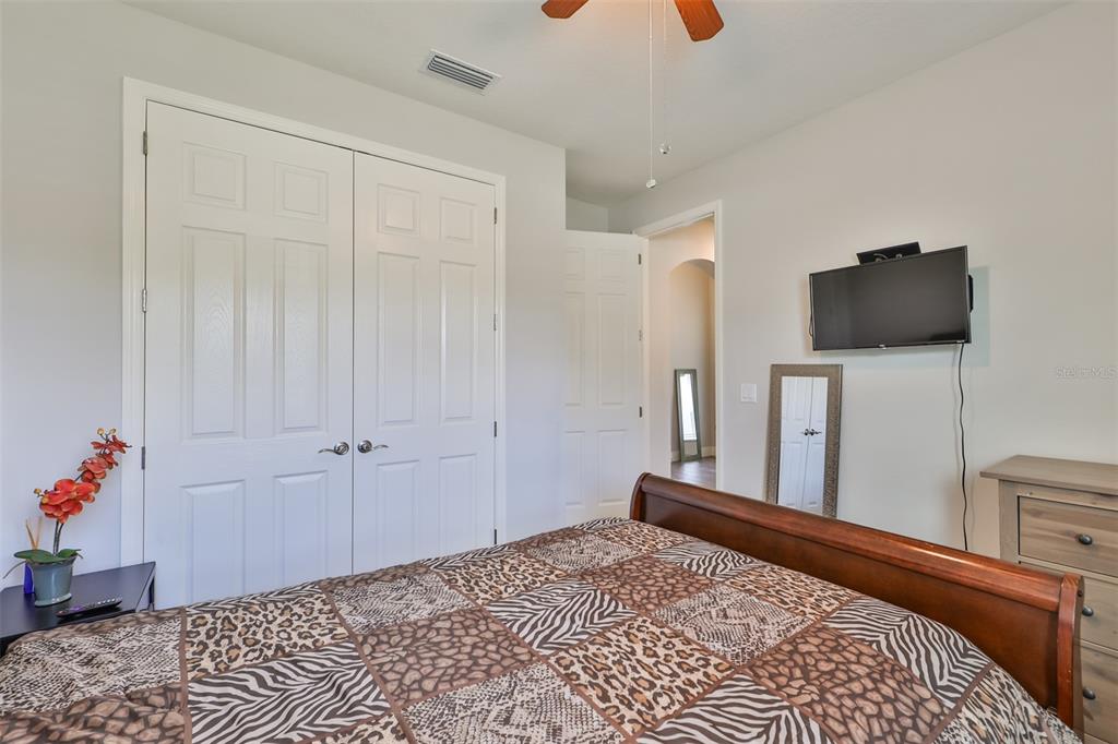 7411 Windport Lane Apollo Beach, FL 33572 - Photo 34 of 71 a bedroom with a bed and a flat tv screen on the dresser