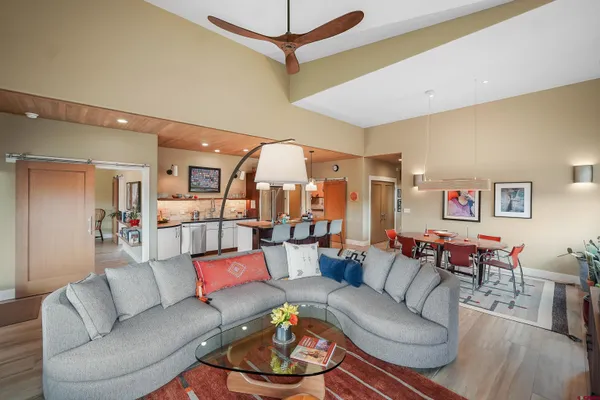 a spacious bathroom with a granite countertop sink a toilet a mirror and shower