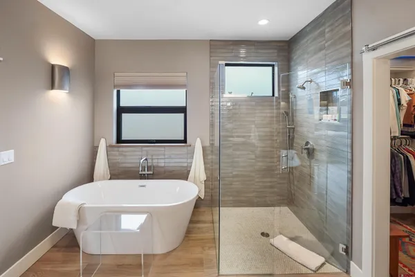 a bathroom with a sink mirror and shower