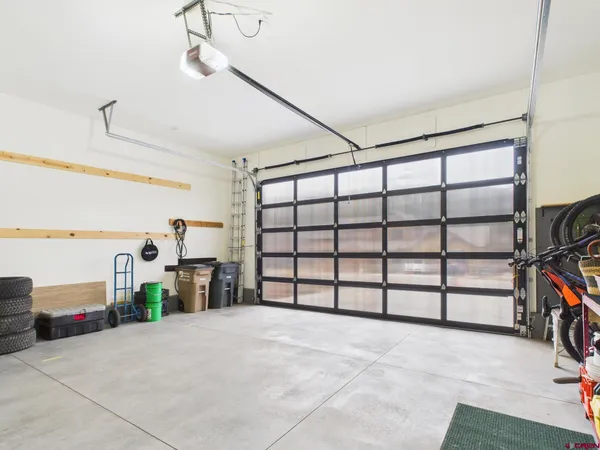 a view of a patio with table and chairs with wooden floor and fence