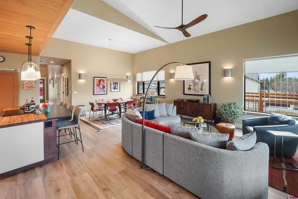 a bed sitting in a spacious bedroom next to a window