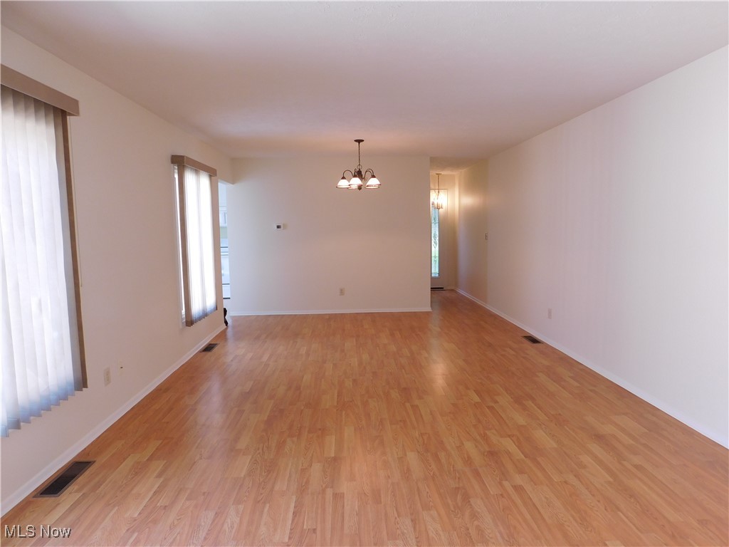 32885 Mills Road North Ridgeville, OH 44039 - Photo 19 of 42 Empty room featuring a chandelier and light wood-style floors