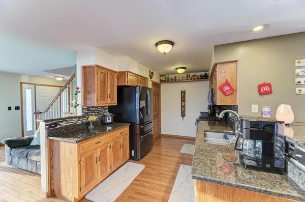 a kitchen with stainless steel appliances granite countertop a sink stove and refrigerator