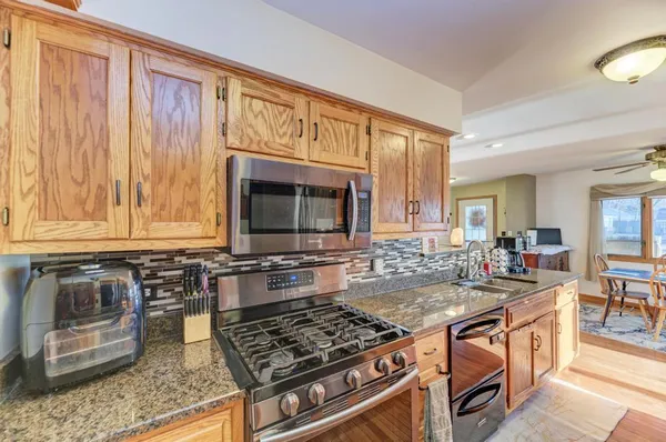 a kitchen with a stove a sink and a microwave