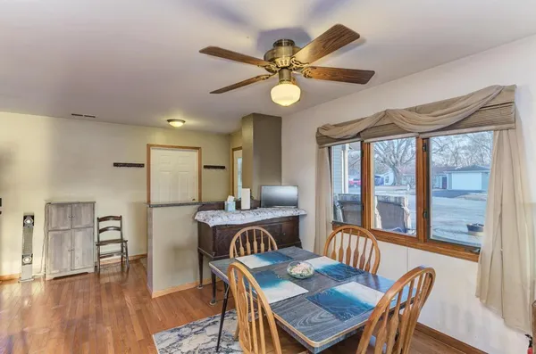 a view of a dining room with furniture window and wooden floor