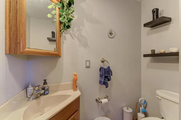 a bathroom with a sink toilet and a mirror
