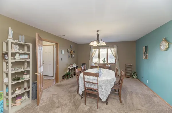 a bed room with a bed and a chandelier