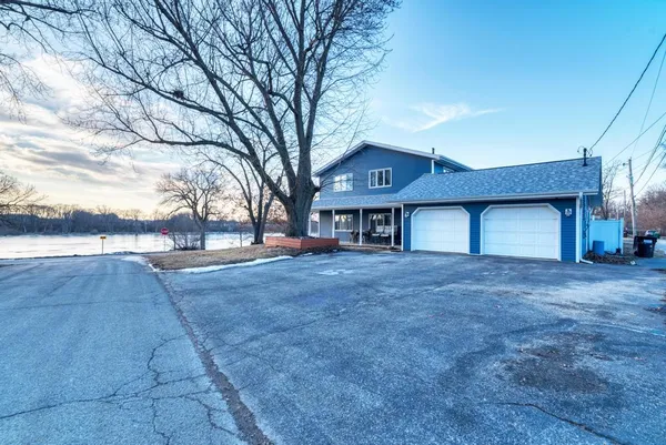 a view of a house with a yard and garage