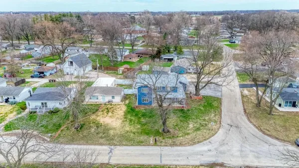 an aerial view of residential houses with outdoor space and street view