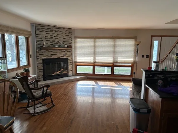 wooden floor fireplace and windows in an empty room