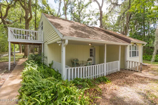 a view of a house with a porch and plants