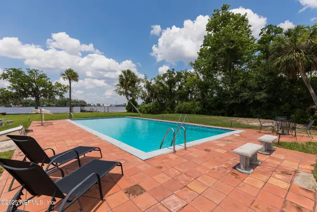 a view of a swimming pool with lounge chairs