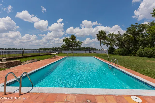 a view of swimming pool with a yard