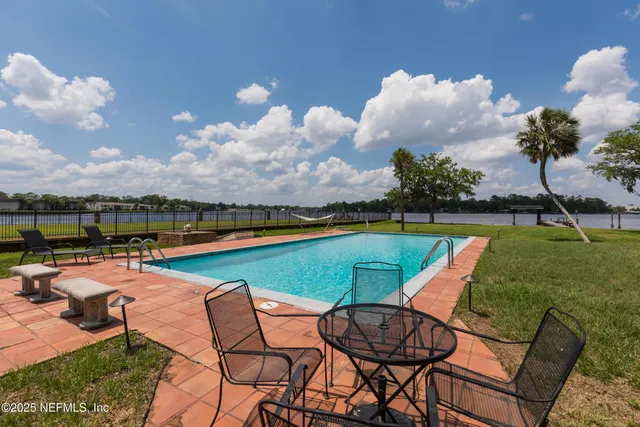 a view of a swimming pool and lounge chairs