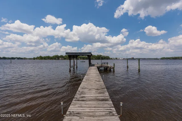 a view of yard with swimming pool and green space