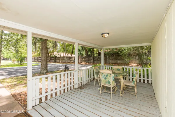 a view of a room with wooden floor and outdoor space
