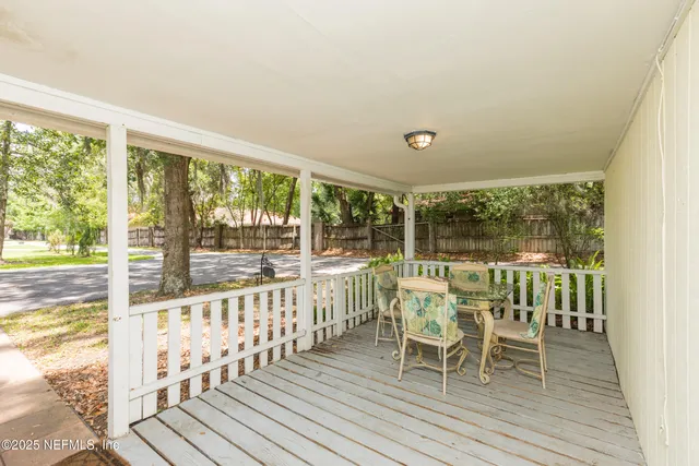 a view of a room with wooden floor and outdoor space