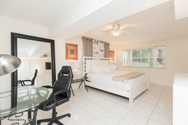 a bedroom with a bed chair and a window