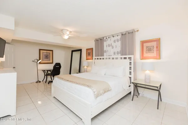 a large white bed in a white room