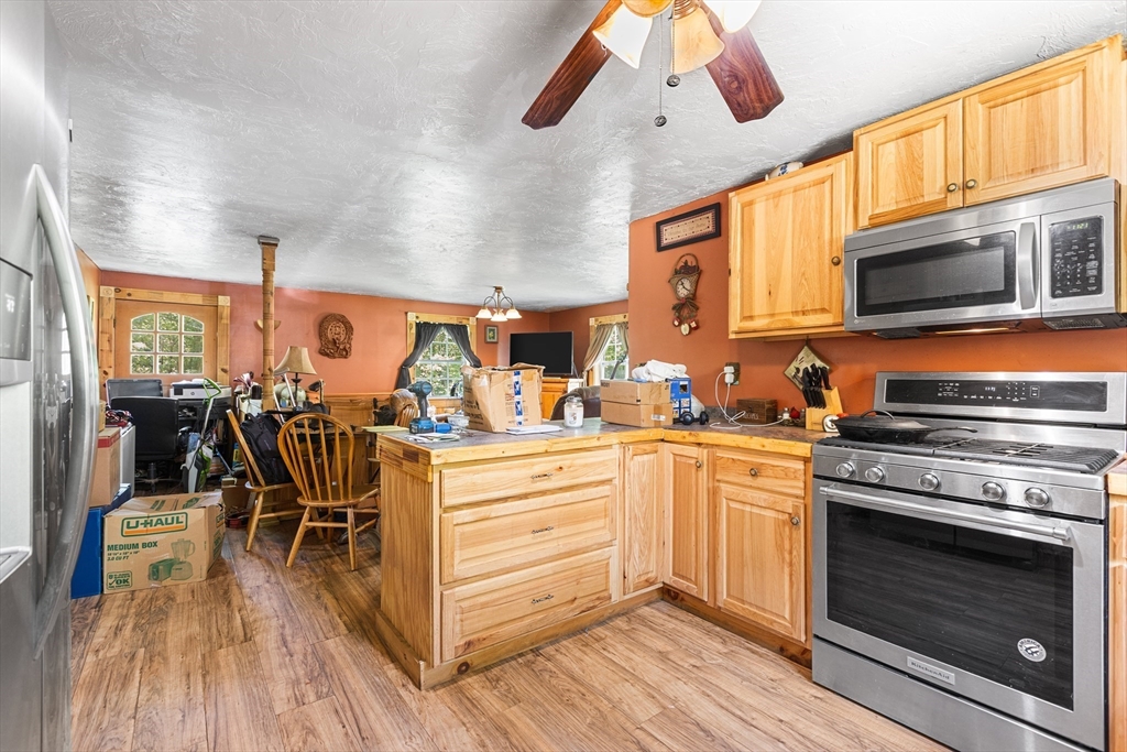 87 W Road Canterbury, NH 03224 - Photo 7 of 21 a kitchen with stainless steel appliances granite countertop a stove and cabinets