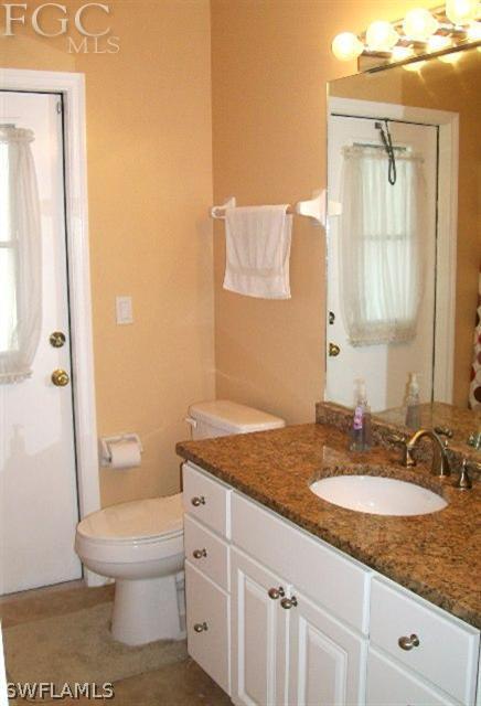 17568 Homewood Road Fort Myers, FL 33967 - Photo 13 of 18 a bathroom with a granite countertop sink toilet and shower