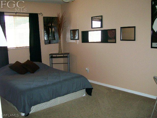 17568 Homewood Road Fort Myers, FL 33967 - Photo 14 of 18 a bedroom with a bed and window