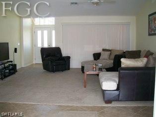17568 Homewood Road Fort Myers, FL 33967 - Photo 4 of 18 a living room with furniture and a flat screen tv