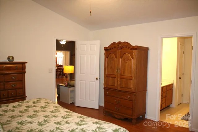 a bedroom with a dresser and a mirror