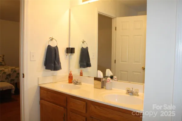 a bathroom with a double vanity sink and mirror