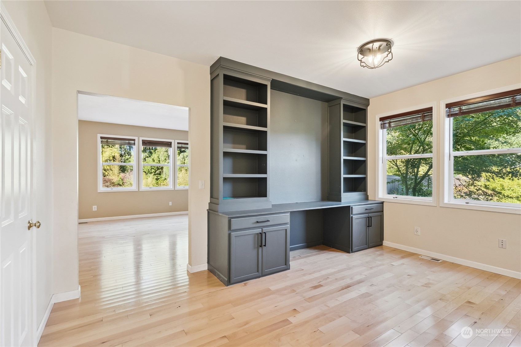 9639 39th Loop Northeast Olympia, WA 98516 - Photo 11 of 38 a large white kitchen with granite countertop a stove a sink and a window