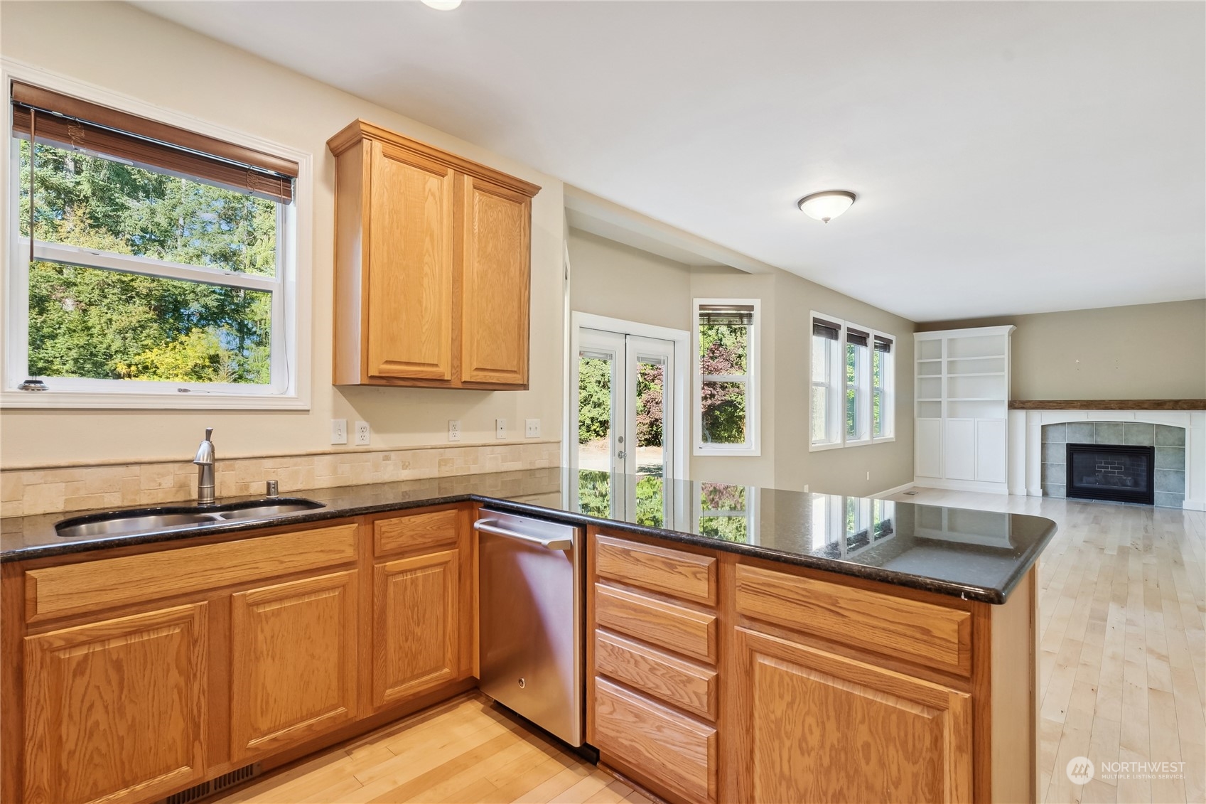 9639 39th Loop Northeast Olympia, WA 98516 - Photo 15 of 38 a kitchen with granite countertop a sink and white cabinets