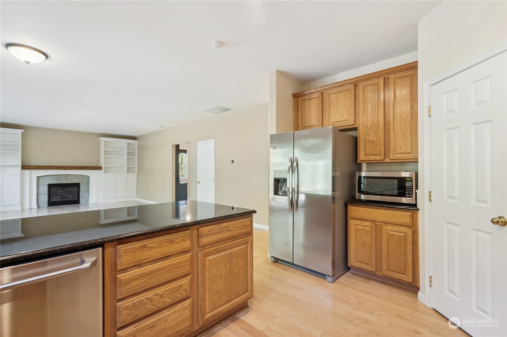 9639 39th Loop Northeast Olympia, WA 98516 - Photo 16 of 38 a kitchen with granite countertop a refrigerator and a sink
